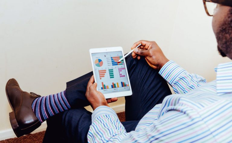 Man calculates payroll on tablet