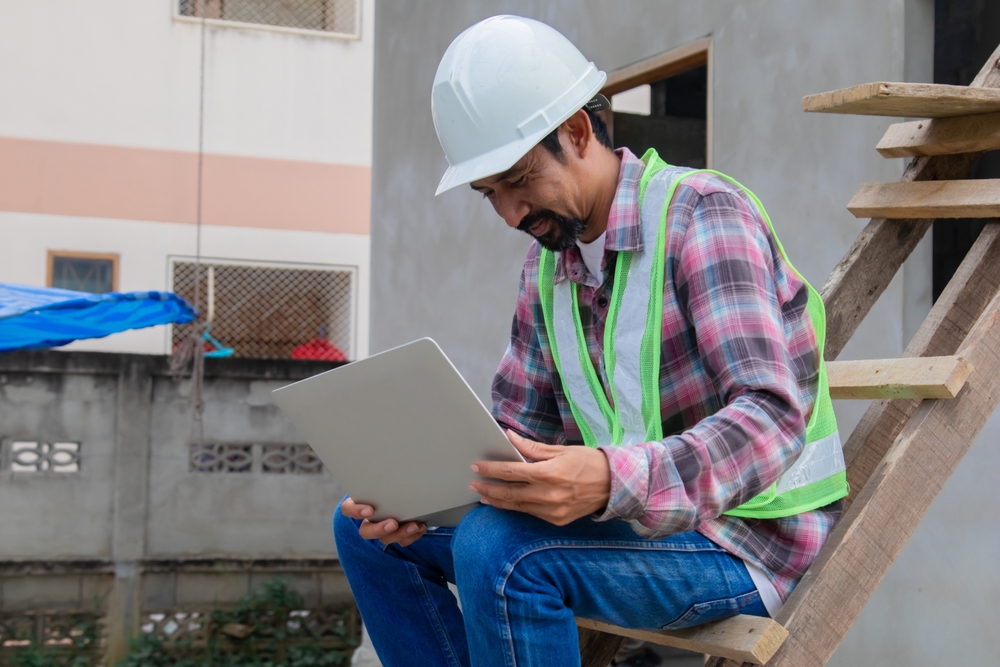 Thoughtful,Indian,Contractor,With,Mustache,Construction,Small,Business,Owner,Using Construction payroll audit risks